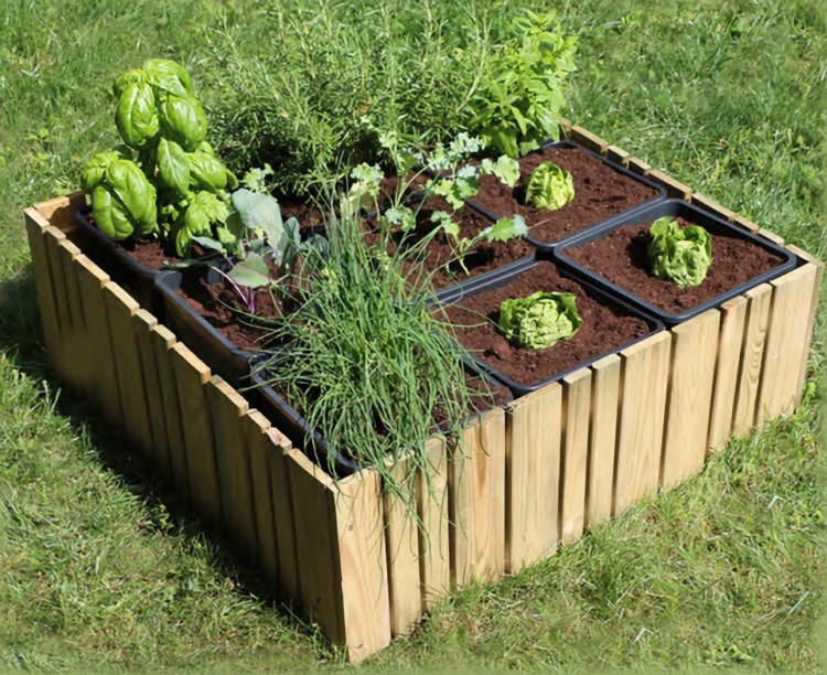 ogrodowa-grzadka-podwyszona-w-ktorej-rosna-ziola-i-warzywa